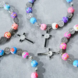 Colorful beaded Saint Benedict medal bracelets with floral Fimo beads and cross pendants