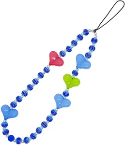 Close-up of colorful striped beads and heart charms on a stylish phone lanyard strap