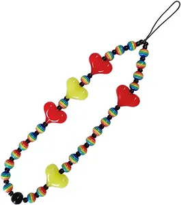 Detail of beaded phone strap with red heart beads and rainbow striped spheres