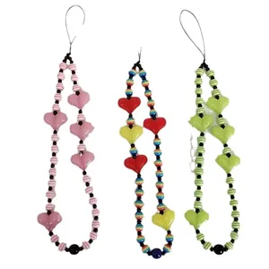 Handmade beaded phone charms with colorful striped beads and plastic heart pendants