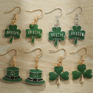 Saint Patrick's Day green clover and Irish hat earring set on a wooden background