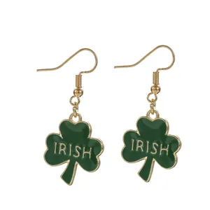 Detailed view of green shamrock drop earrings with IRISH text and gold-tone alloy hooks