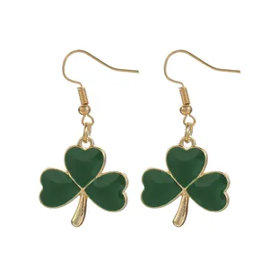 Detailed view of green enamel shamrock earrings with gold alloy hooks for St. Patrick's Day