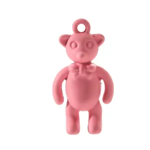 Detailed view of a matte pink bear pendant with a bow for DIY jewelry making