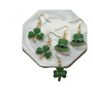 Saint Patrick's Day green clover earrings with Irish top hat charms on marble display