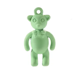 Close-up of mint green alloy bear charm with bow tie for DIY jewelry making