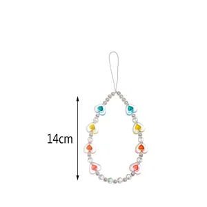 Detail of 14cm bohemian phone charm with colorful resin hearts and pearl beads
