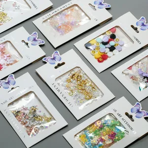 Detail of assorted nail art ornaments in card packaging with pearls and resin bows
