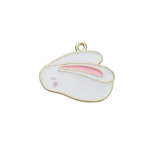Macro detail of white enamel rabbit charm with gold metal edges for DIY jewelry making