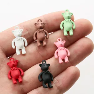 Colorful bear charms in six matte colors held in hand to show actual scale for DIY jewelry