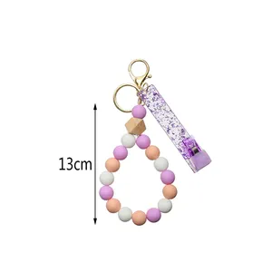 Porte-clés bracelet en perles de silicone avec fermoir doré et perle en bois, 13cm