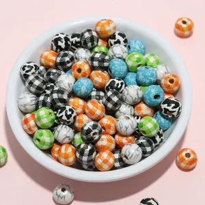 Close-up of 8mm mixed pattern wooden beads with floral and plaid prints in a ceramic bowl