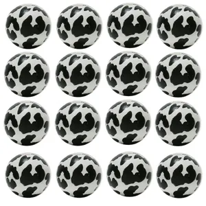 Macro detail of 16-piece set of round wooden beads with black and white animal print pattern
