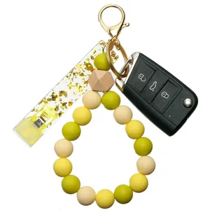 Détail d'un porte-clés en perles de silicone avec pendentif en acrylique doré