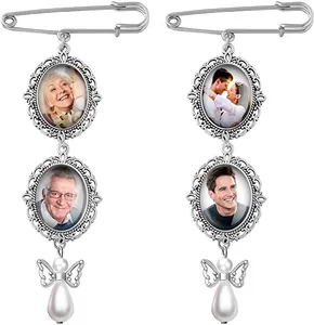 Close-up of vintage silver wedding bouquet pins with photo charms and pearl angel wing drops