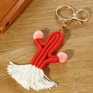 Detail of red handmade woven cactus keychain with tassel and golden metal lobster clasp