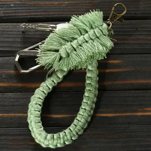 Detailed view of handmade sage green macrame leaf charm with bronze lobster clasp