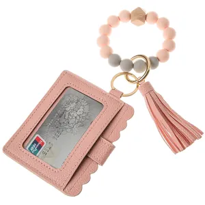 Pink faux leather card holder detail with silicone beads tassel and golden metal clasp