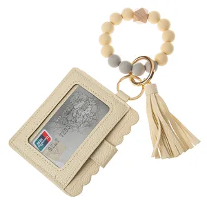 Close-up of silicone bead wristlet with leather card holder and tassel keychain