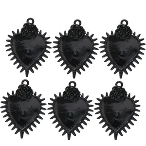 Macro detail of six black gothic heart pendants with thorns and rose for DIY jewelry
