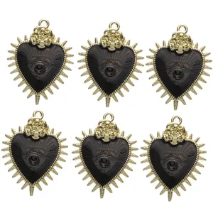 Detail of heart pendants with black enamel, gold spikes and rose accents in six-piece set