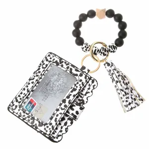 Detail of leopard print card holder and beaded wristlet with gold lobster clasp