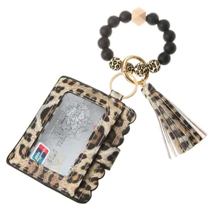 Close-up of leopard print card holder with silicone bead wristlet and gold hardware