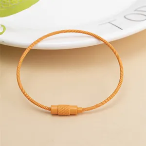 Close-up of bright orange nylon coated wire keychain with textured screw lock