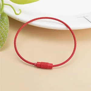 Macro shot of red coated steel wire keychain with secure screw clasp and non-slip texture