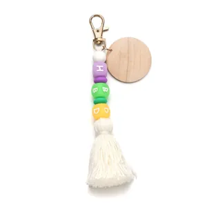 Detail of HBD silicone beads with wooden tag and white cotton tassel keychain