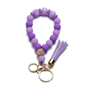 Bracelet porte-clés perles en silicone violettes lumineuses avec perle en bois et gland