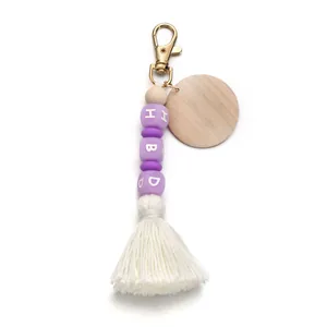 Detailed view of silicone beads and HBD letter blocks with wooden disc and white tassel