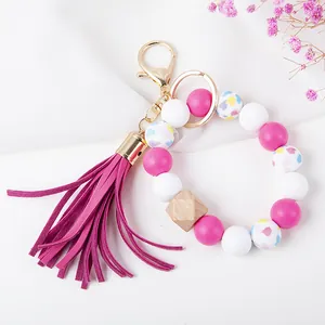 Pink and white silicone beaded keychain with heart patterns, wood bead and long tassel