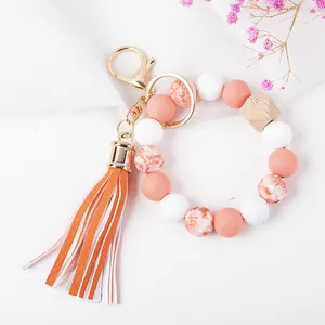 Detail of beaded keychain with tassel, silicone beads and heart pattern I love you bead