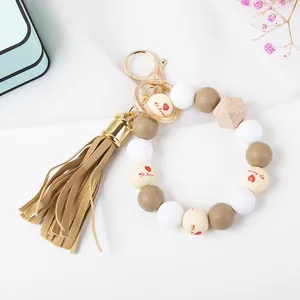 Close-up of beaded keychain with tassel, silicone beads and I love you engraving