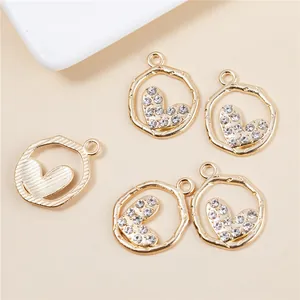 Hollow heart pendants set in gold with rhinestones and brushed finish for jewelry making
