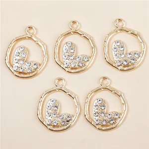 Five gold irregular hollow pendants with sparkling rhinestone hearts for DIY jewelry making