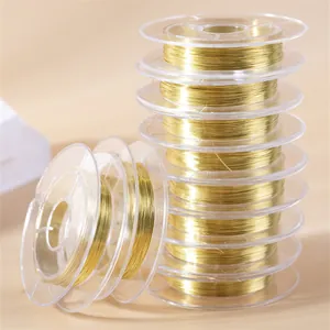 Stack of 0.3mm gold copper craft wires on clear spools for DIY jewelry making