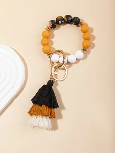 Detailed view of bohemian silicone bead keychain with tricolor fringe tassel and golden ring