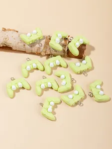 Detailed view of light green resin game controller charms with silver metal rings