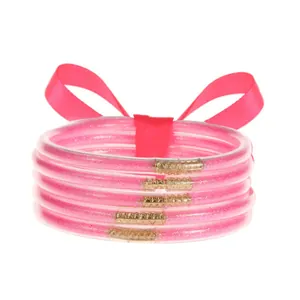 Set de 5 brazaletes de silicona con purpurina rosa y lazo decorativo elegante