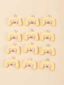 Top view of cream and lilac resin game controller charms for DIY jewelry making