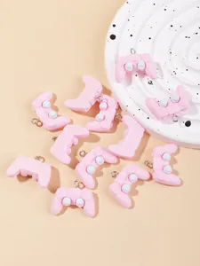 Macro view of pastel pink resin game controller pendants for DIY keychain accessories