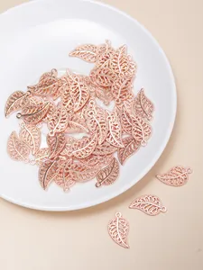 Macro detail of rose gold alloy hollow leaf charms for DIY jewelry and bracelets
