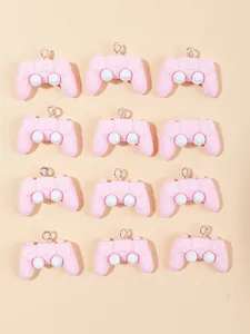 Flat lay of 12 pink resin game controller charms for DIY crafts and jewelry making