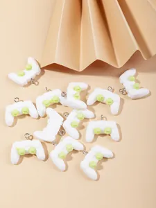 Macro view of miniature white resin game controller pendants for DIY jewelry making