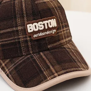 Detailed macro shot of brown plaid wool baseball cap with Boston embroidery