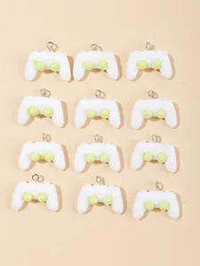 Flat lay macro of twelve white resin gamepad pendants for creative DIY jewelry making