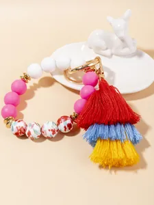 Macro view of floral printed silicone beads and colorful tassel keychain bracelet