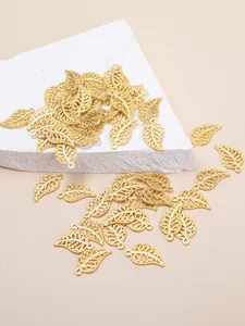 Macro view of gold hollow leaf charms with detailed textures for DIY jewelry making